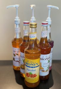 monin brand syrups arranged in a triagle